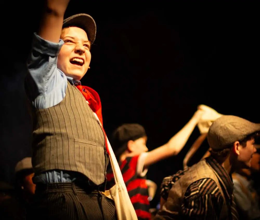 A newsie mid-scene