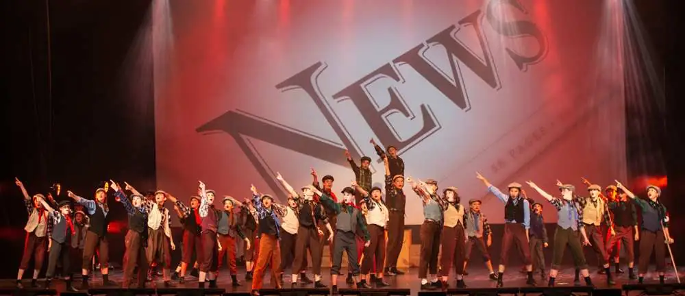 The newsies pointing out to the audience