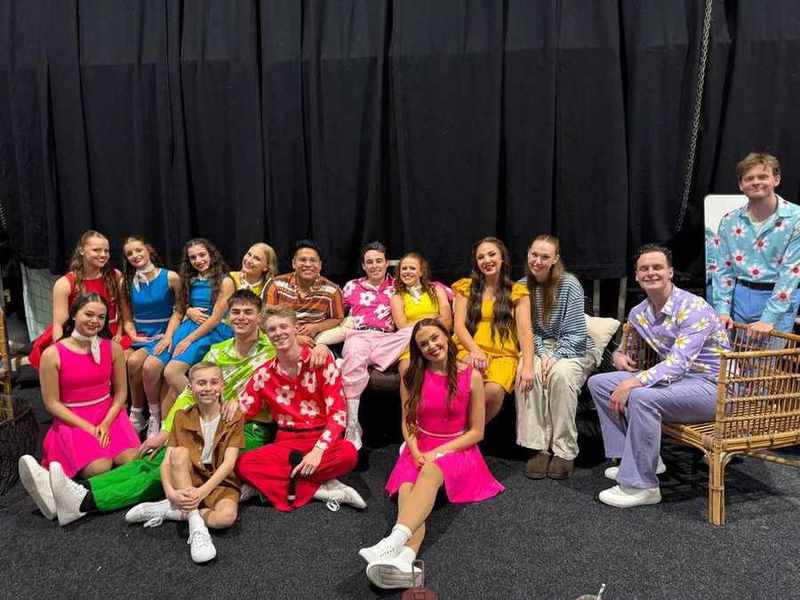 The G'day Adventure cast gathered backstage in bright costumes