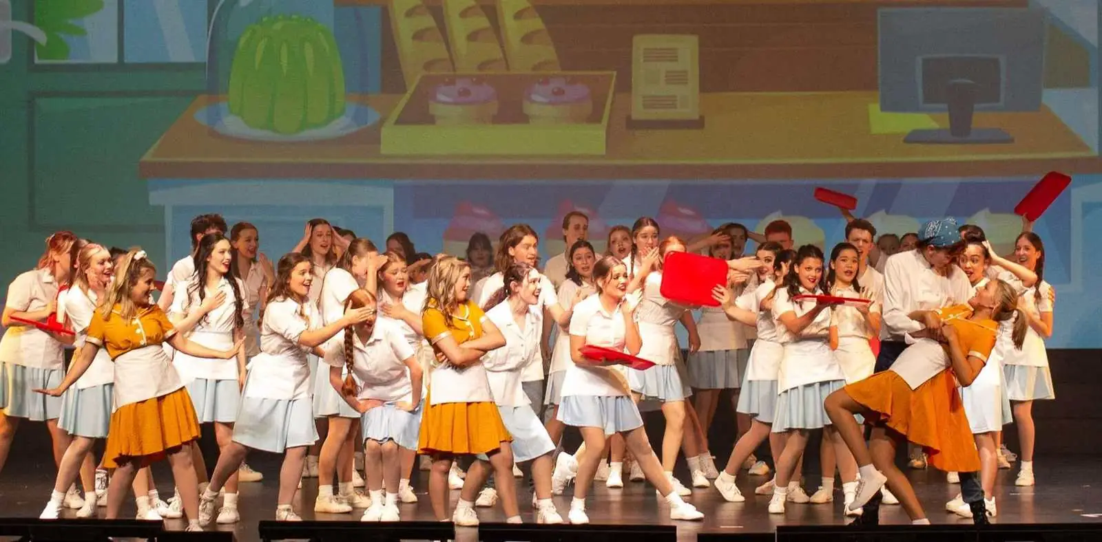 A Pelican company mid-comedy in a bakery scene